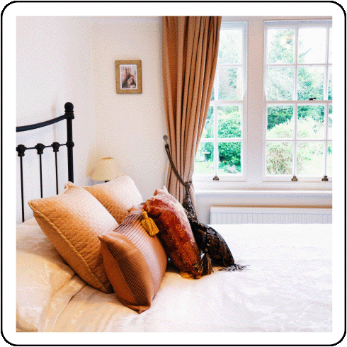 Image description: A hotel bed with pillows.
