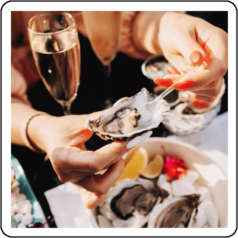 Image description: A person eating oysters.