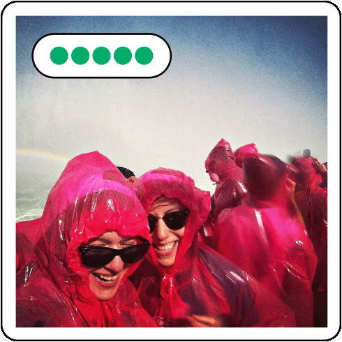 Image description: two women in pink ponchos at Niagara Falls.